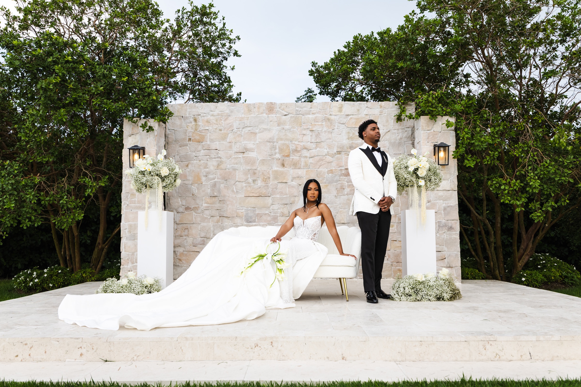 Bride and groom posed in a modern outdoor garden setting