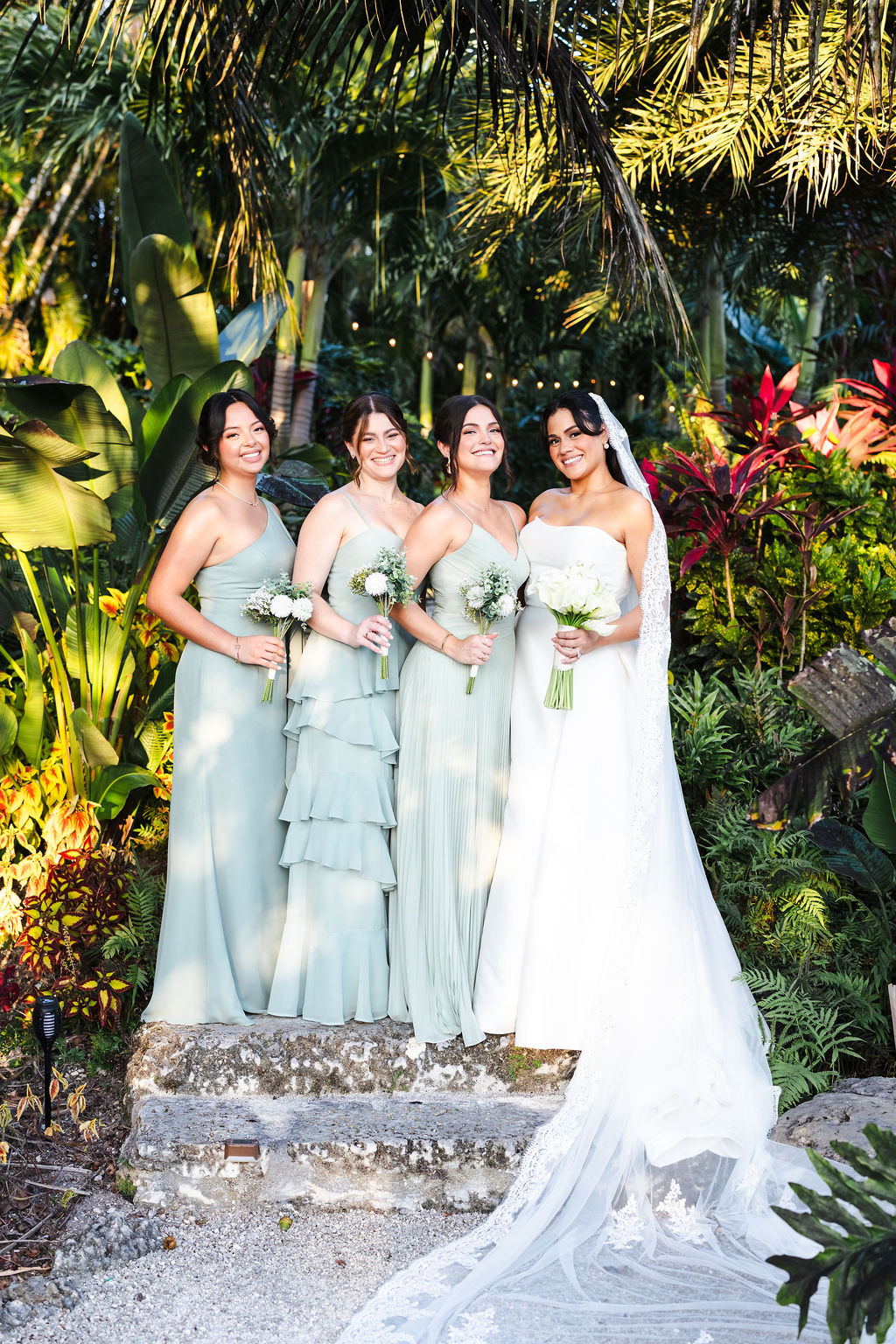 Ana and her wedding party surrounded by tropical greenery