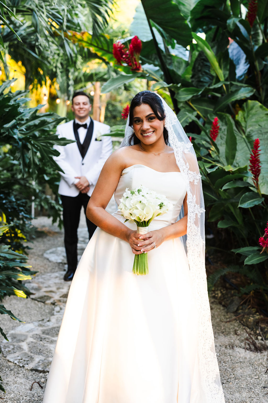 Ana in a sunlit bridal portrait among the palms