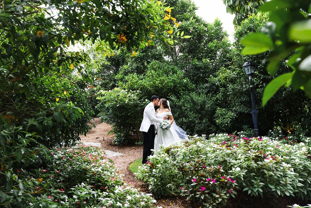 The newlyweds surrounded by flowering plants and tropical greenery