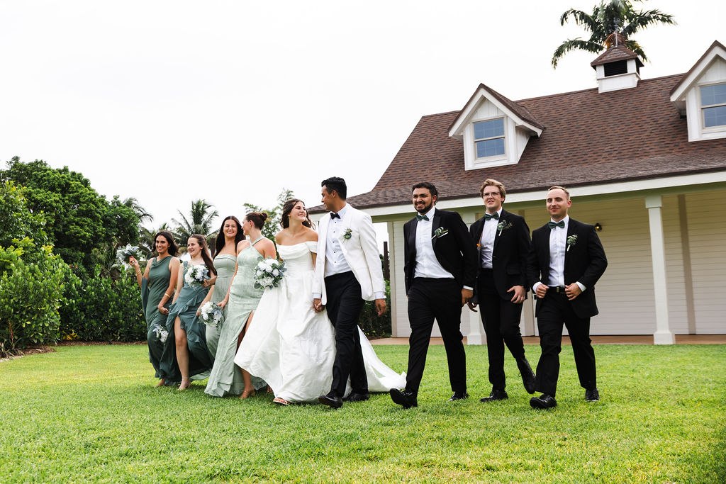 The wedding party celebrating with Leah and Jose on the lawn