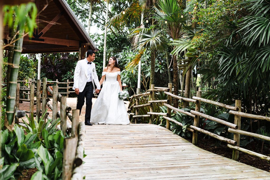 Leah and Jose walking along a wooden garden path