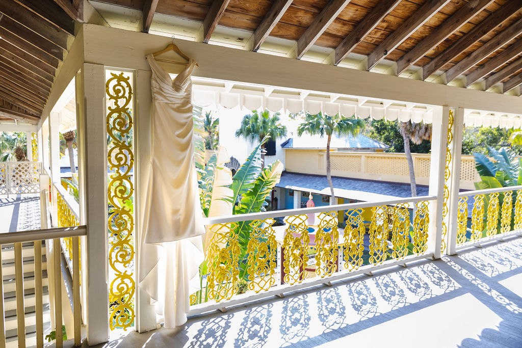 The Bonnet House balcony with yellow railings and a view of the courtyard