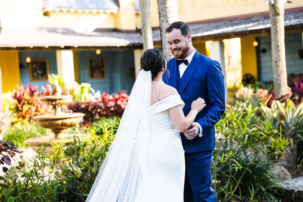 Sara and Brett holding hands in the Bonnet House courtyard
