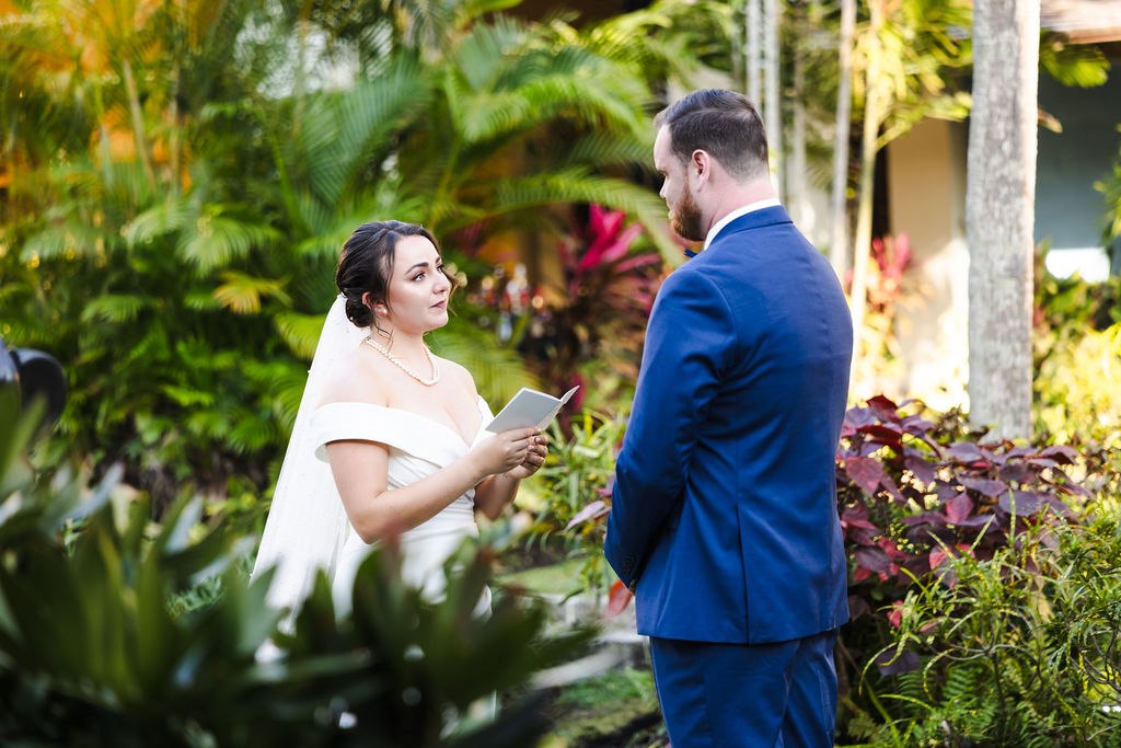 Sara smiling at Brett among the courtyard plants