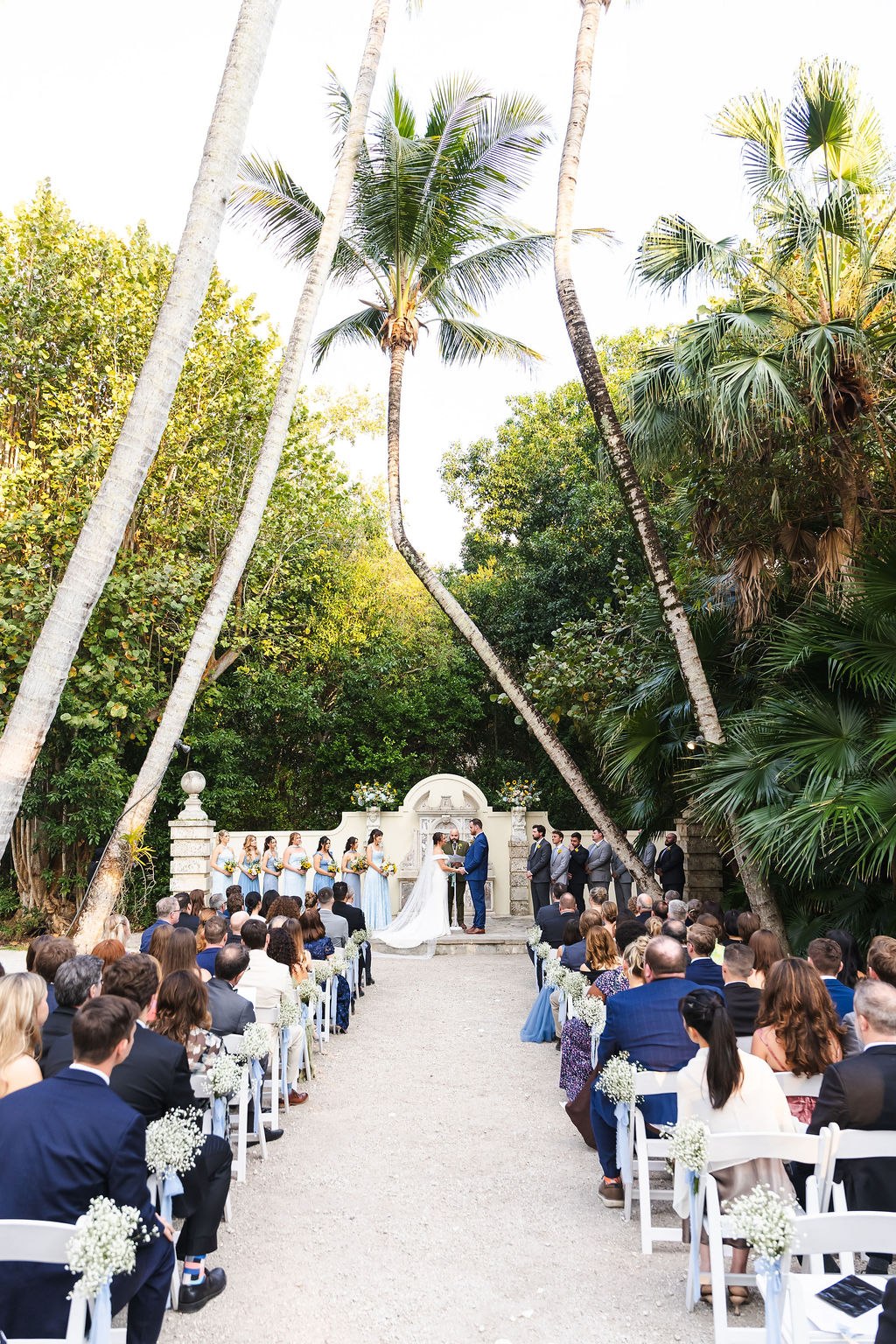 Wide view of the Bonnet House outdoor ceremony beneath the palms