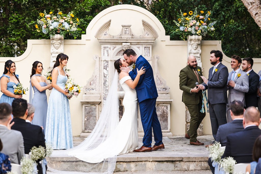Sara and Brett sharing their first kiss at the outdoor ceremony