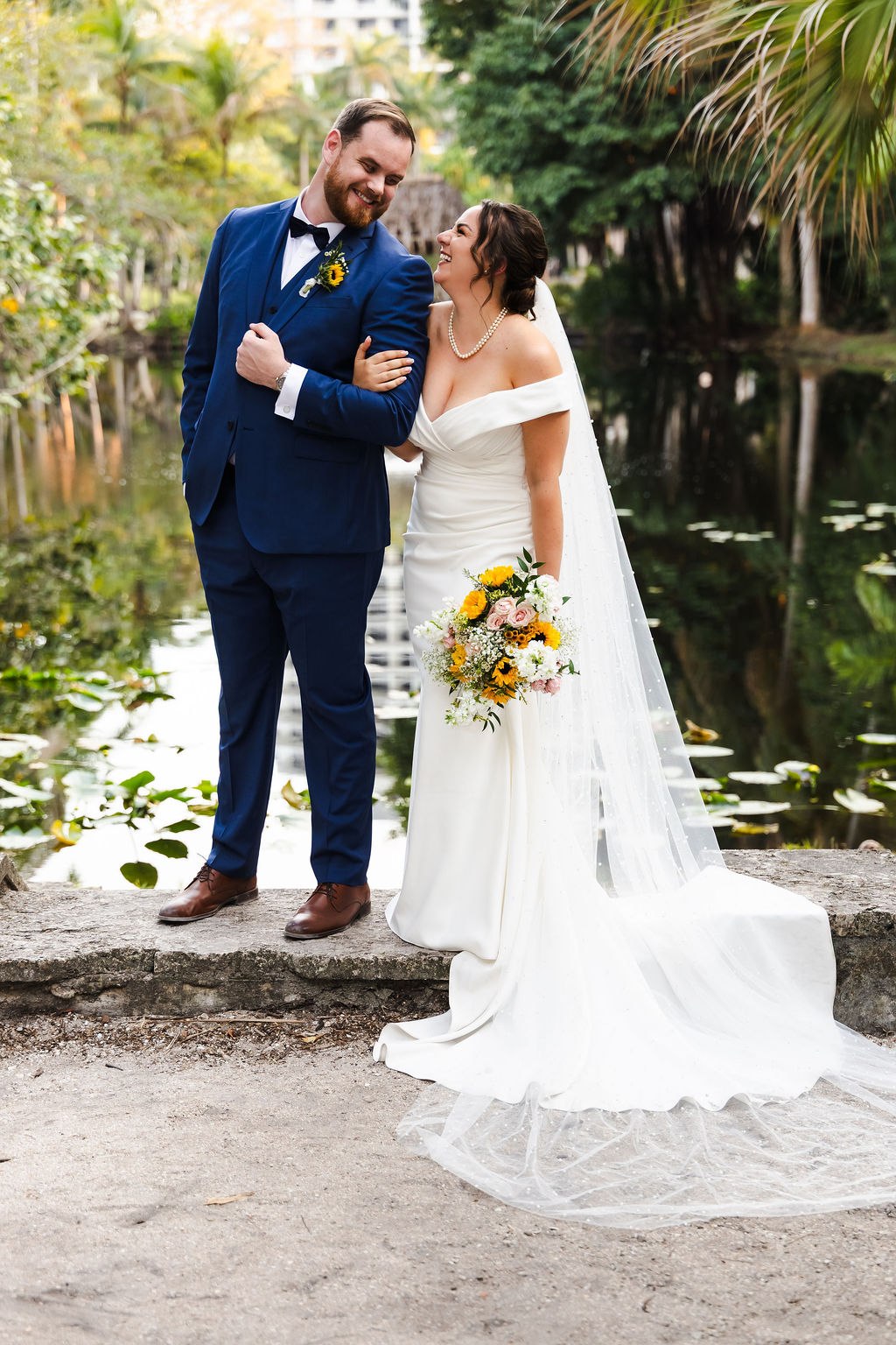Sara and Brett laughing together along a garden path