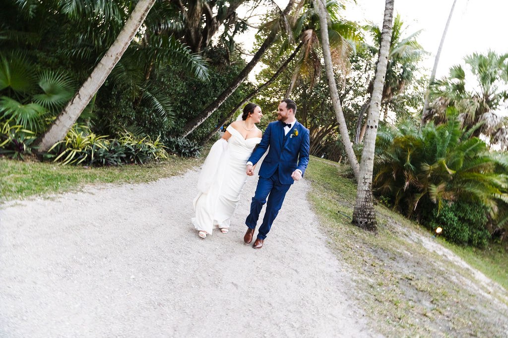 Sara and Brett walking together beneath the palms