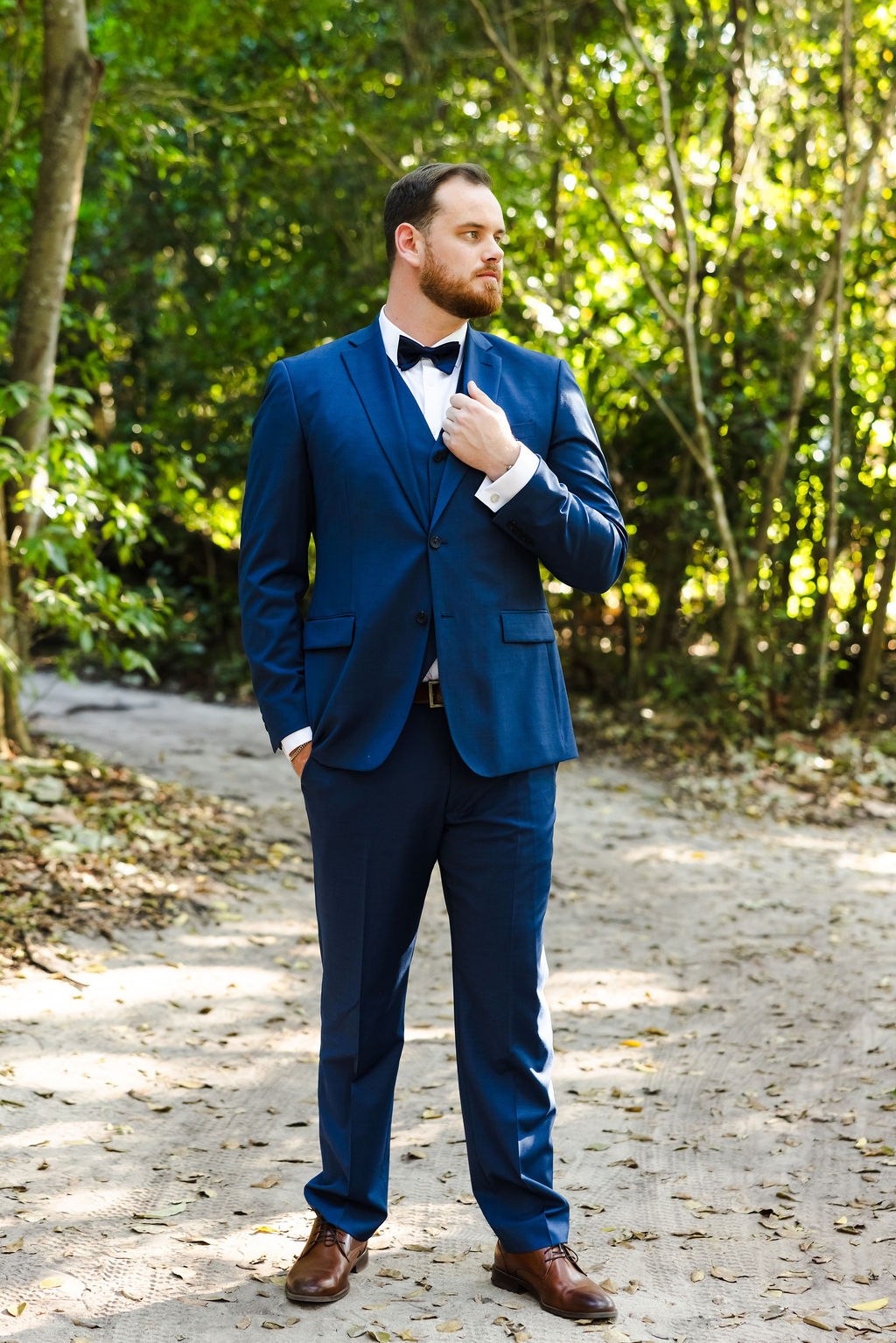 Brett in his blue wedding suit beneath the palms