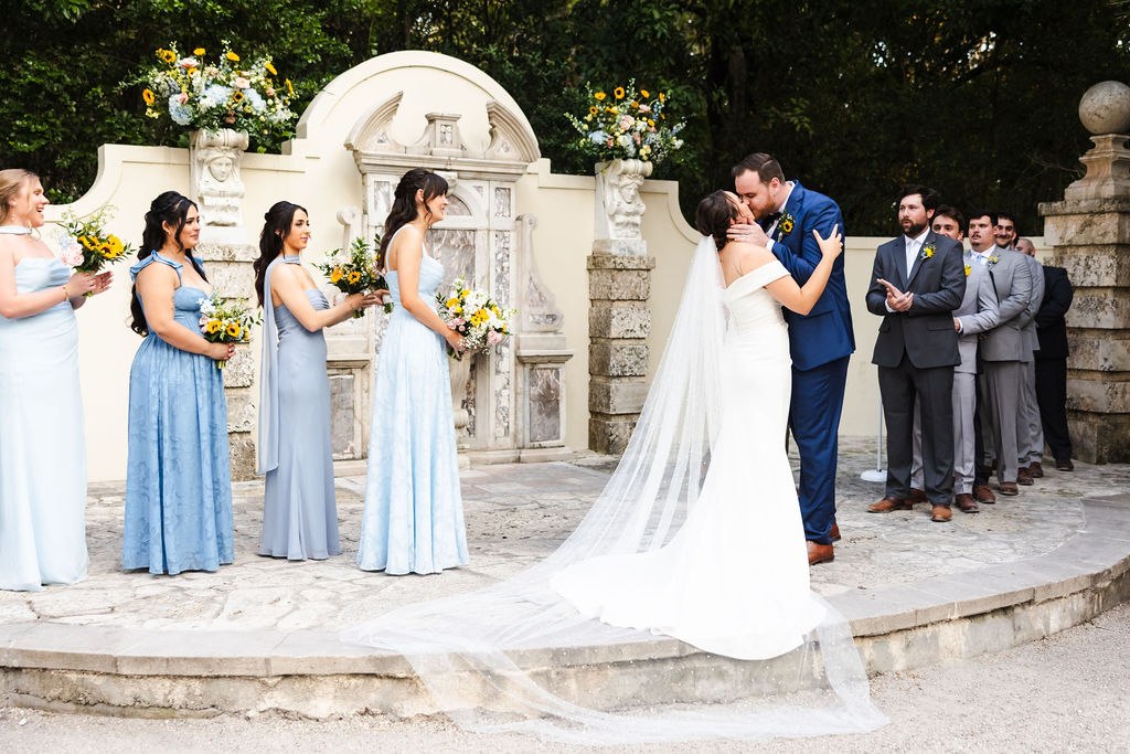 Sara and Brett exchanging vows in front of the fountain backdrop