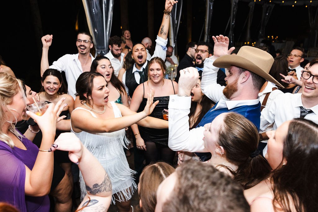 Sara and Brett celebrating with guests on the dance floor