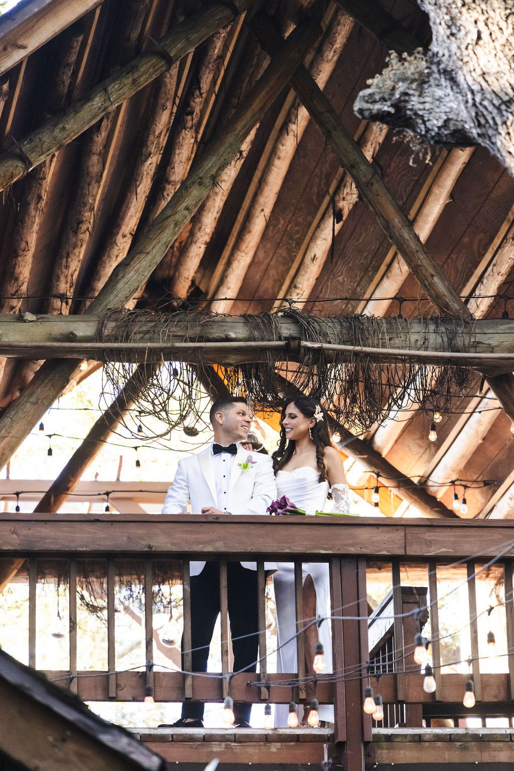 Bryn and Edward beneath the rustic wood architecture at Living Sculpture Sanctuary