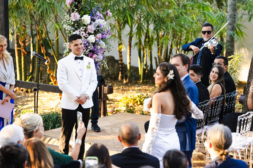 Edward watching Bryn enter their outdoor garden ceremony
