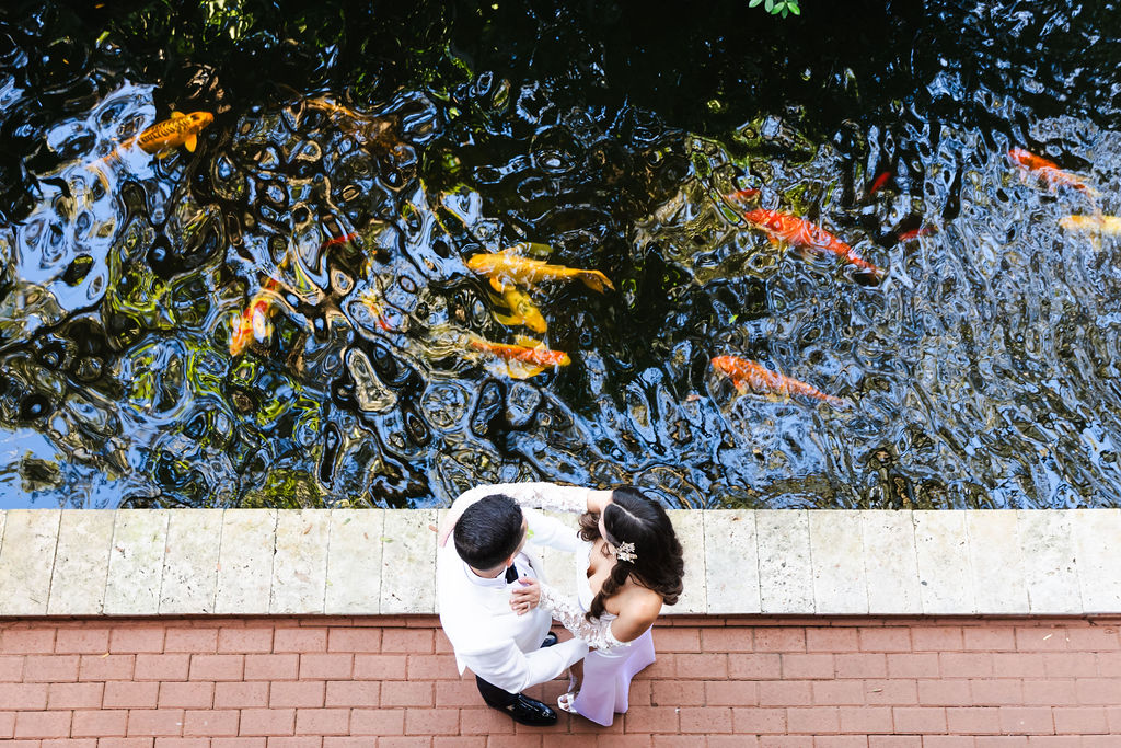 Overhead portrait of Bryn and Edward beside colorful koi