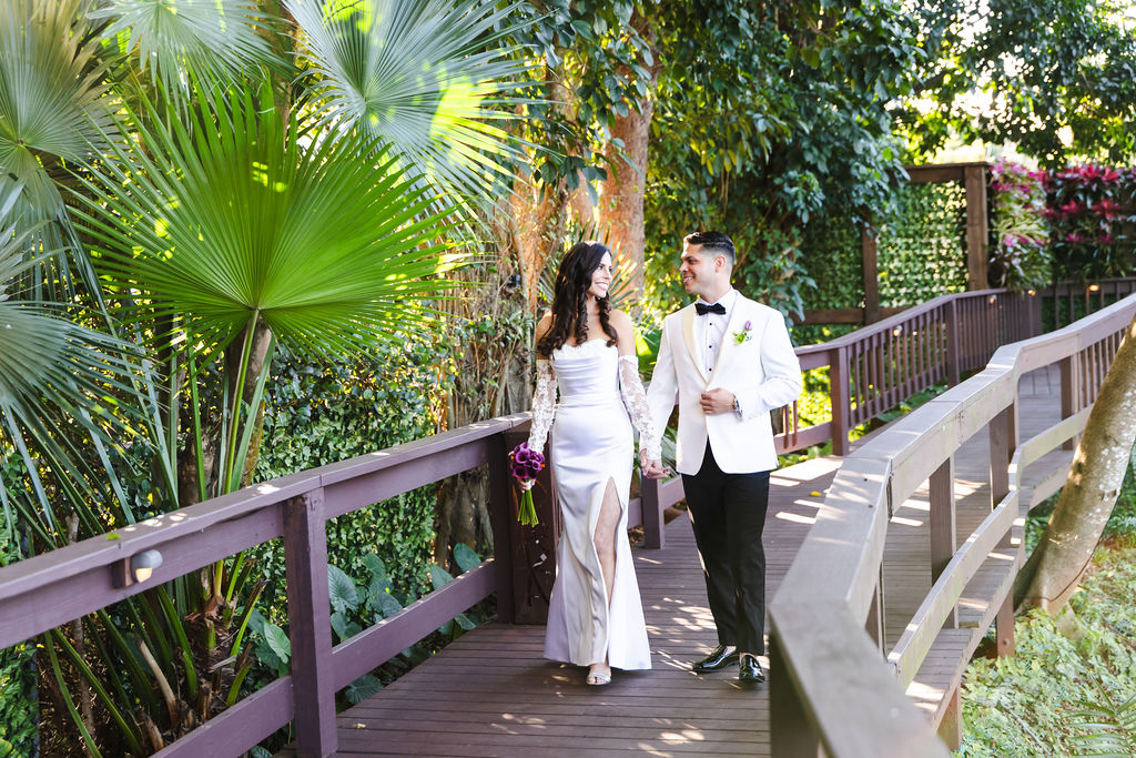 Bryn and Edward walking together through the tropical gardens