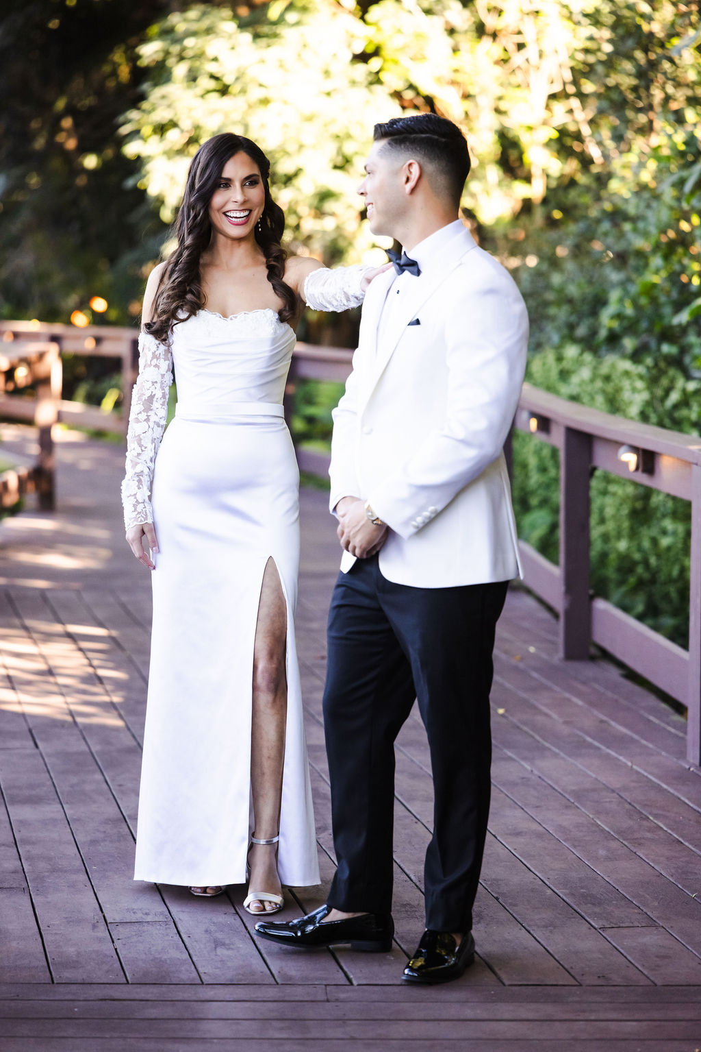 Bryn and Edward laughing together on a garden walkway