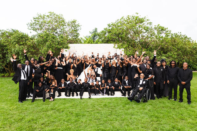 Large group portrait celebrating with the newlyweds