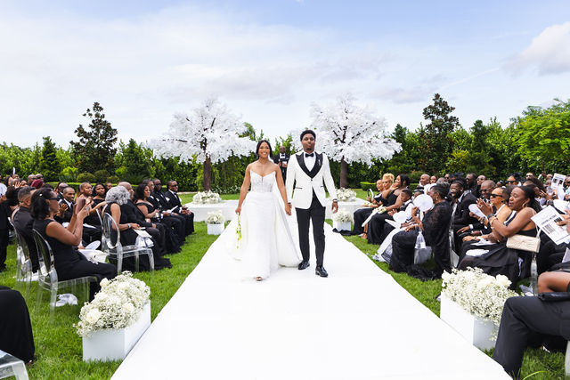 Chrispin and Netania walking back up the aisle together