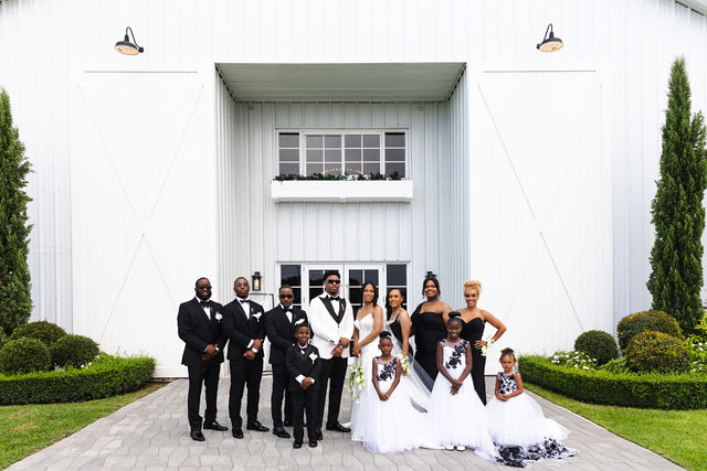Wedding party portrait outside The White Orchid