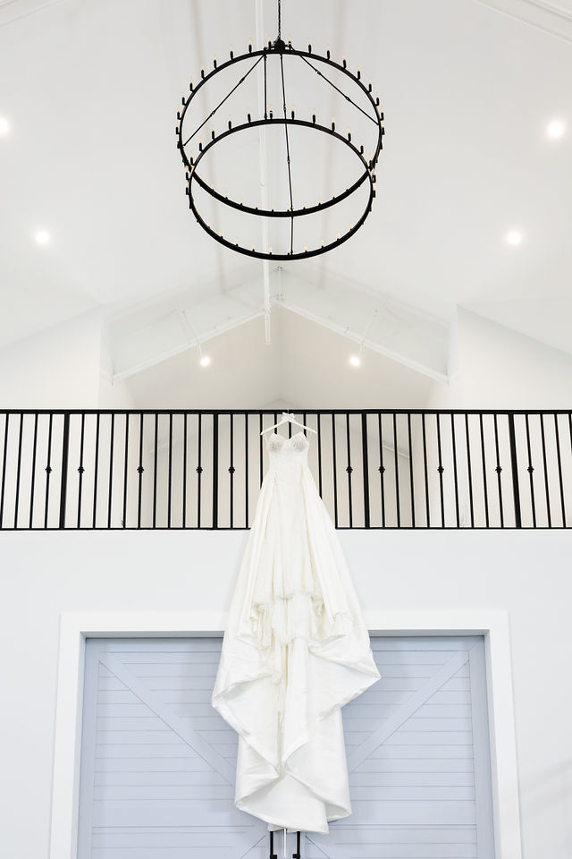 The White Orchid interior with modern chandelier and wedding dress