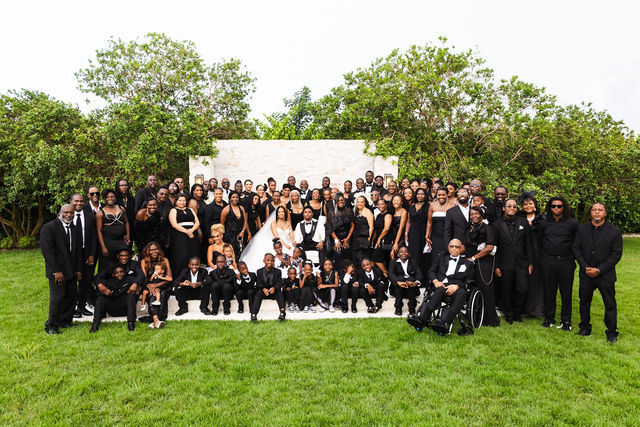 Chrispin and Netania surrounded by family and friends on the lawn