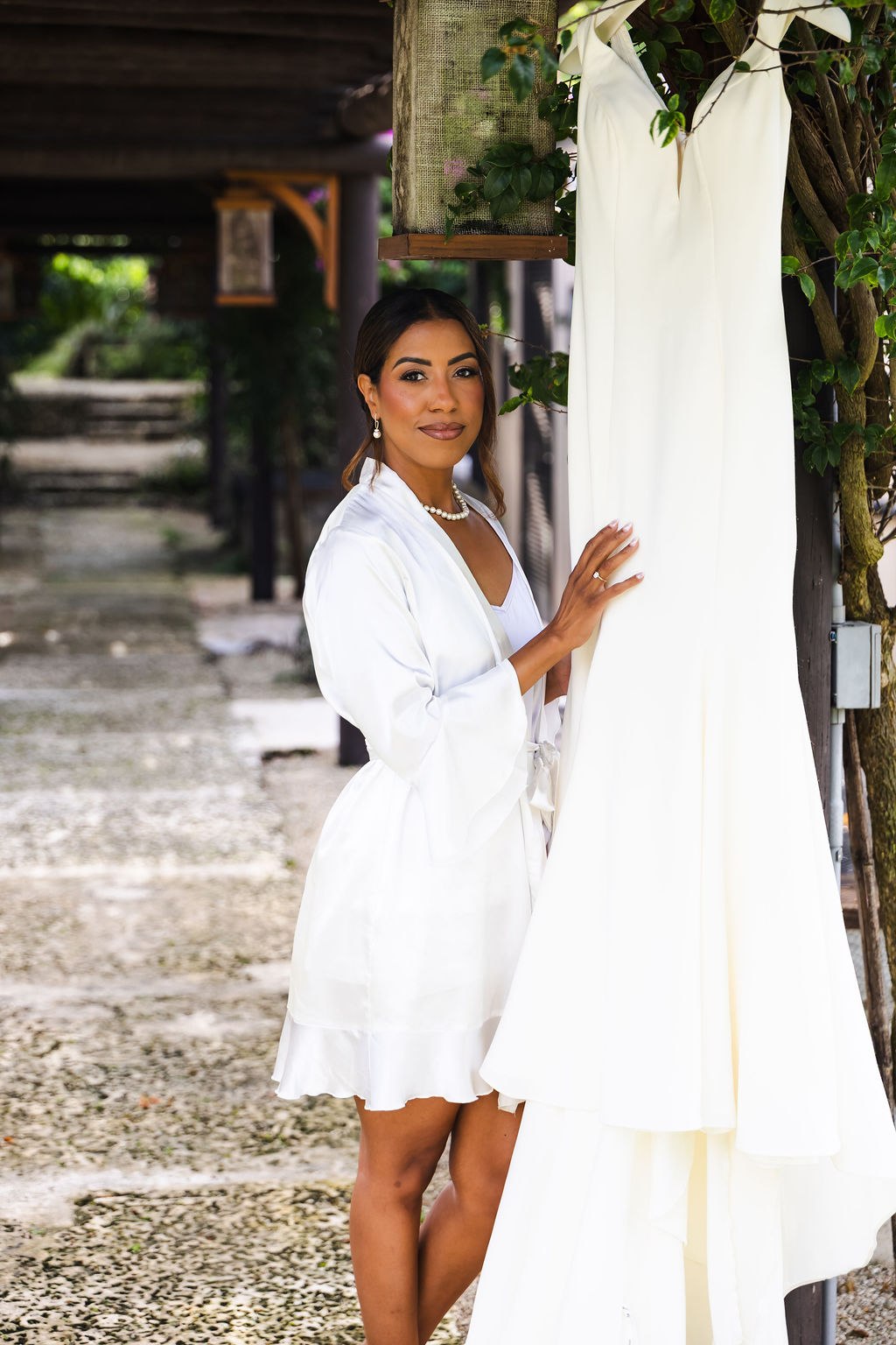 Sharlena smiling beside her wedding dress before the ceremony