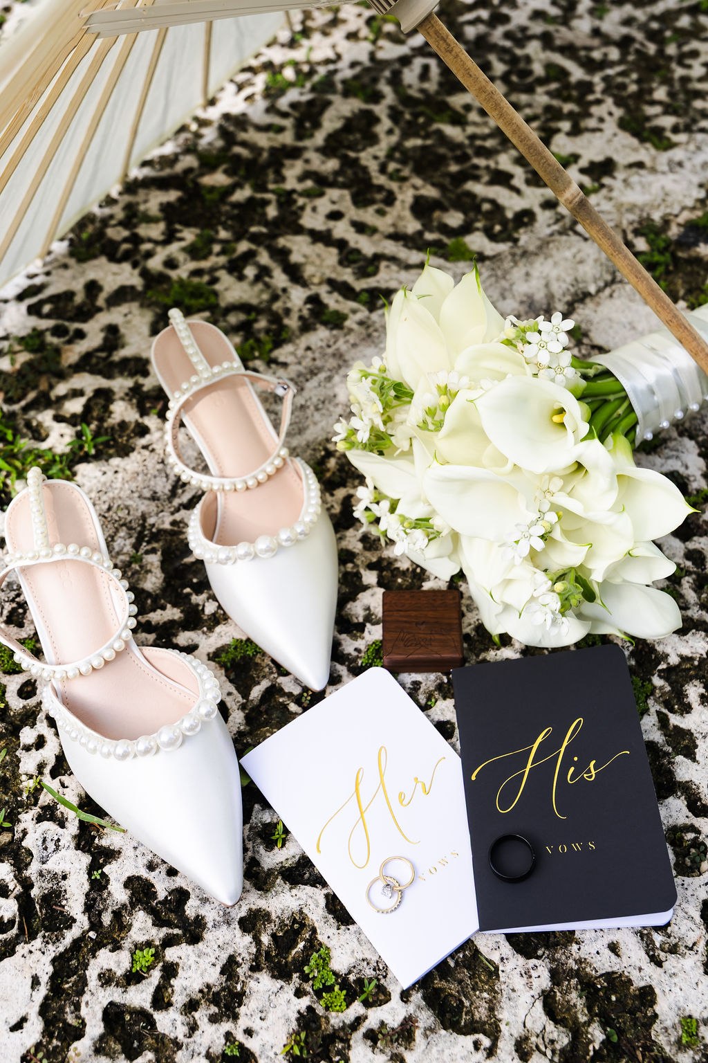 Bridal shoes, invitation and white flowers arranged before the wedding