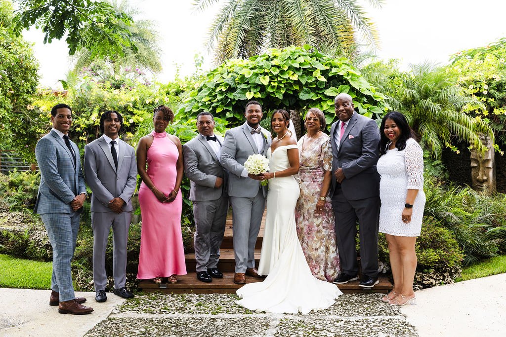 Adrian, Sharlena and their guests gathered for a garden group portrait