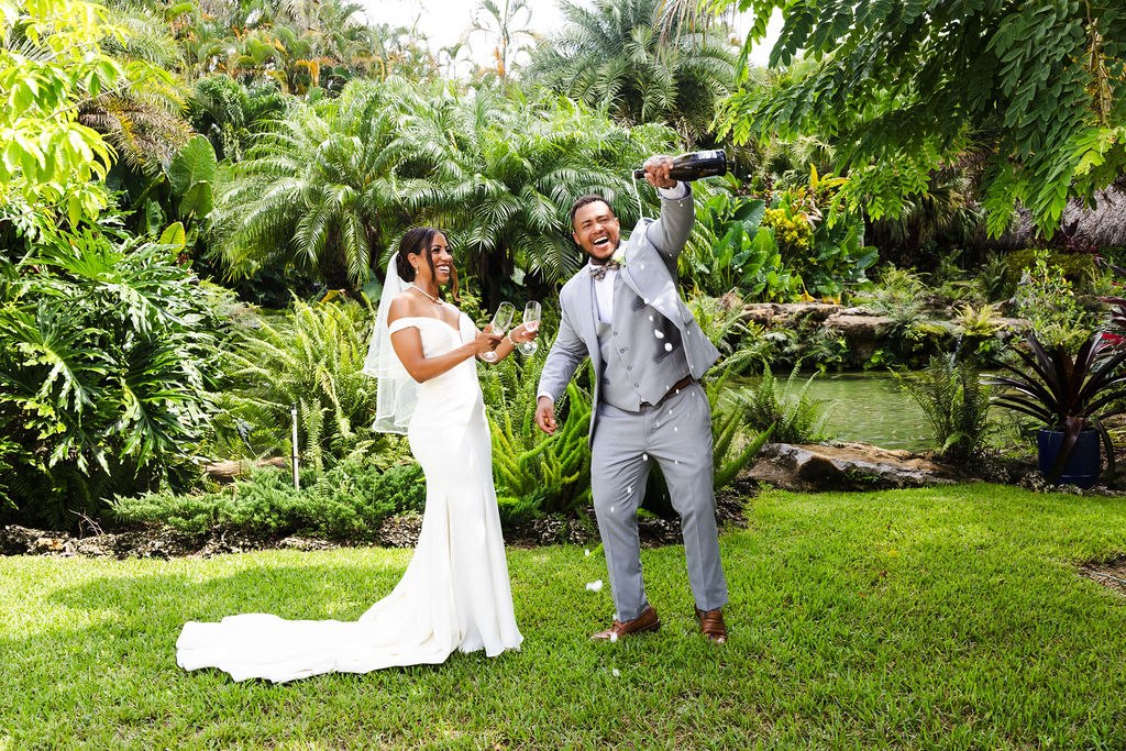 Adrian and Sharlena celebrating together beside the garden pond