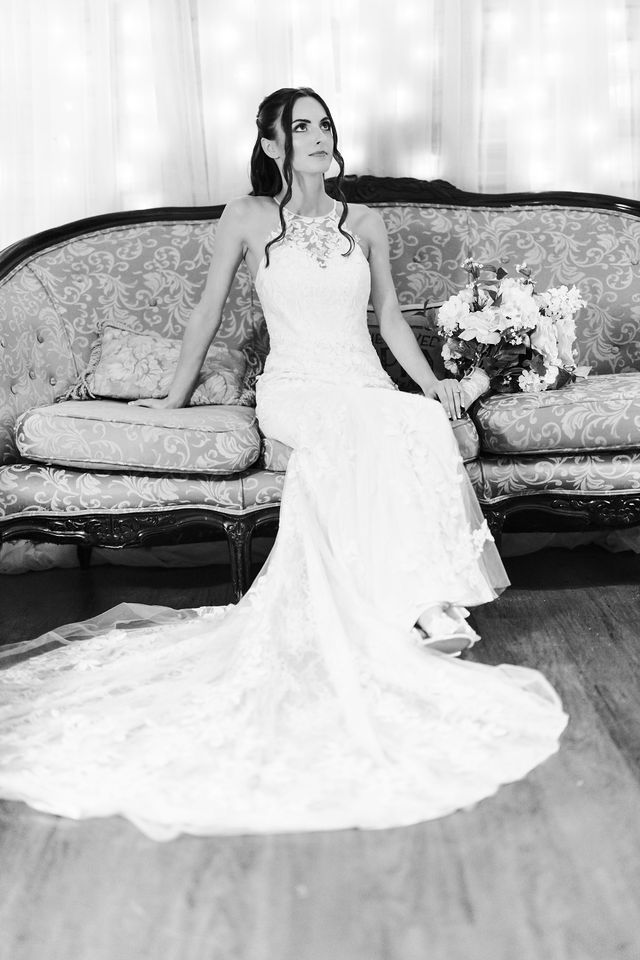 Black and white bridal portrait on a vintage sofa