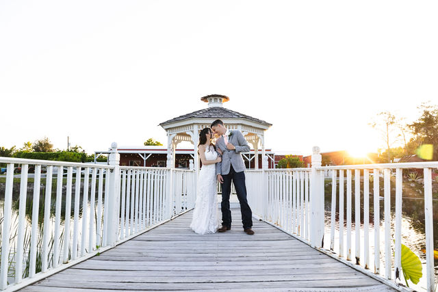 Newlyweds standing together on the white bridge