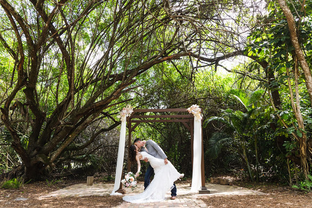 Newlyweds sharing a quiet moment under the trees