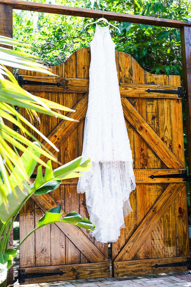Wedding dress hanging against rustic wood at Rayshell Ranch