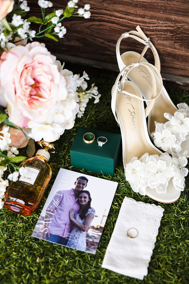 Wedding shoes, rings and keepsakes arranged with flowers