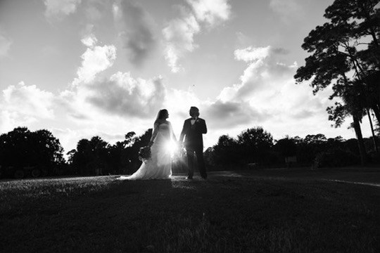 Black-and-white portrait of Nina and Ayrton against the open ranch sky