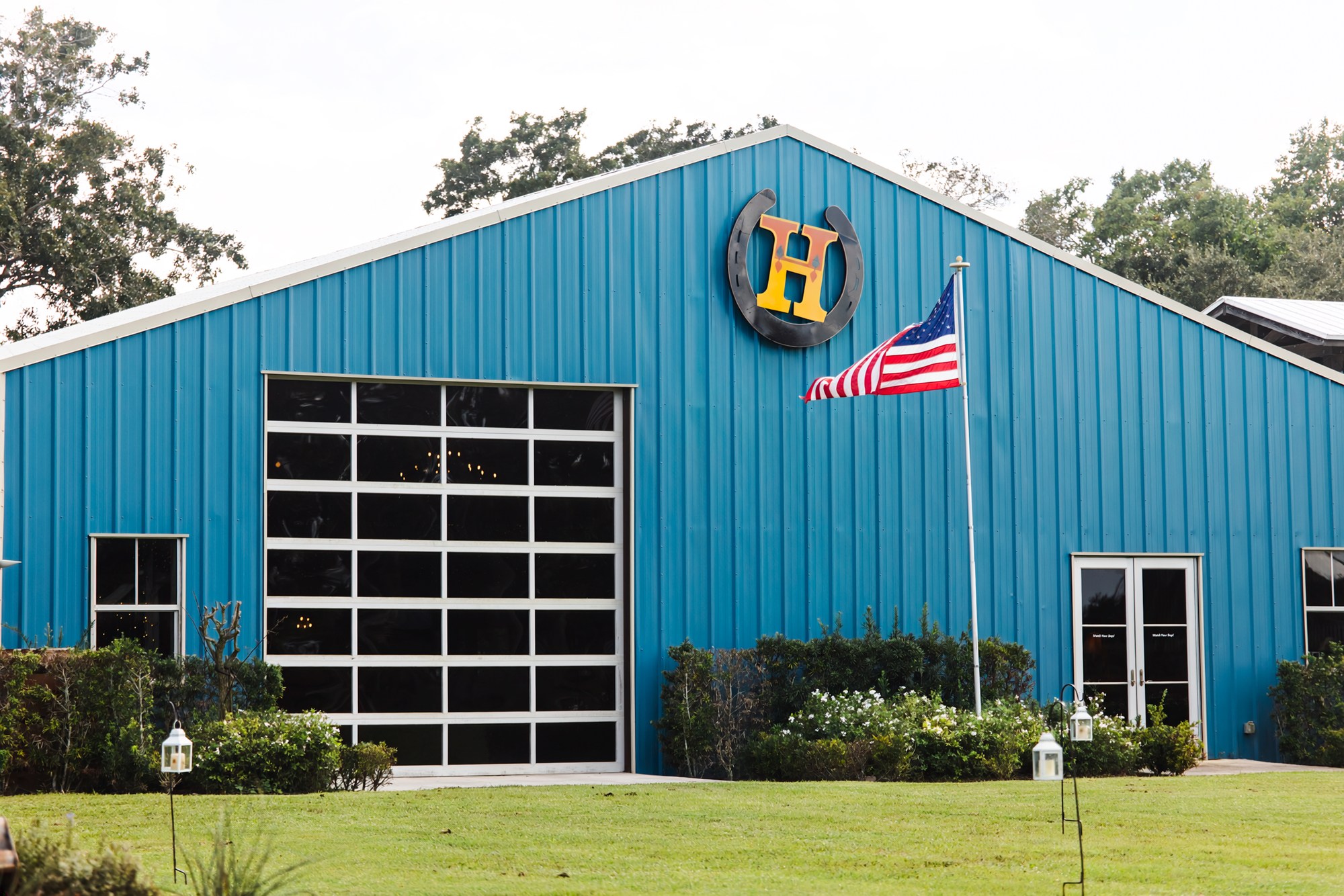 The blue barn at Rockin H Ranch with its horseshoe H emblem