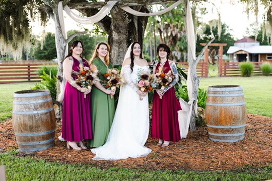 Nina and her bridesmaids beneath the draped oak tree at Rockin H Ranch