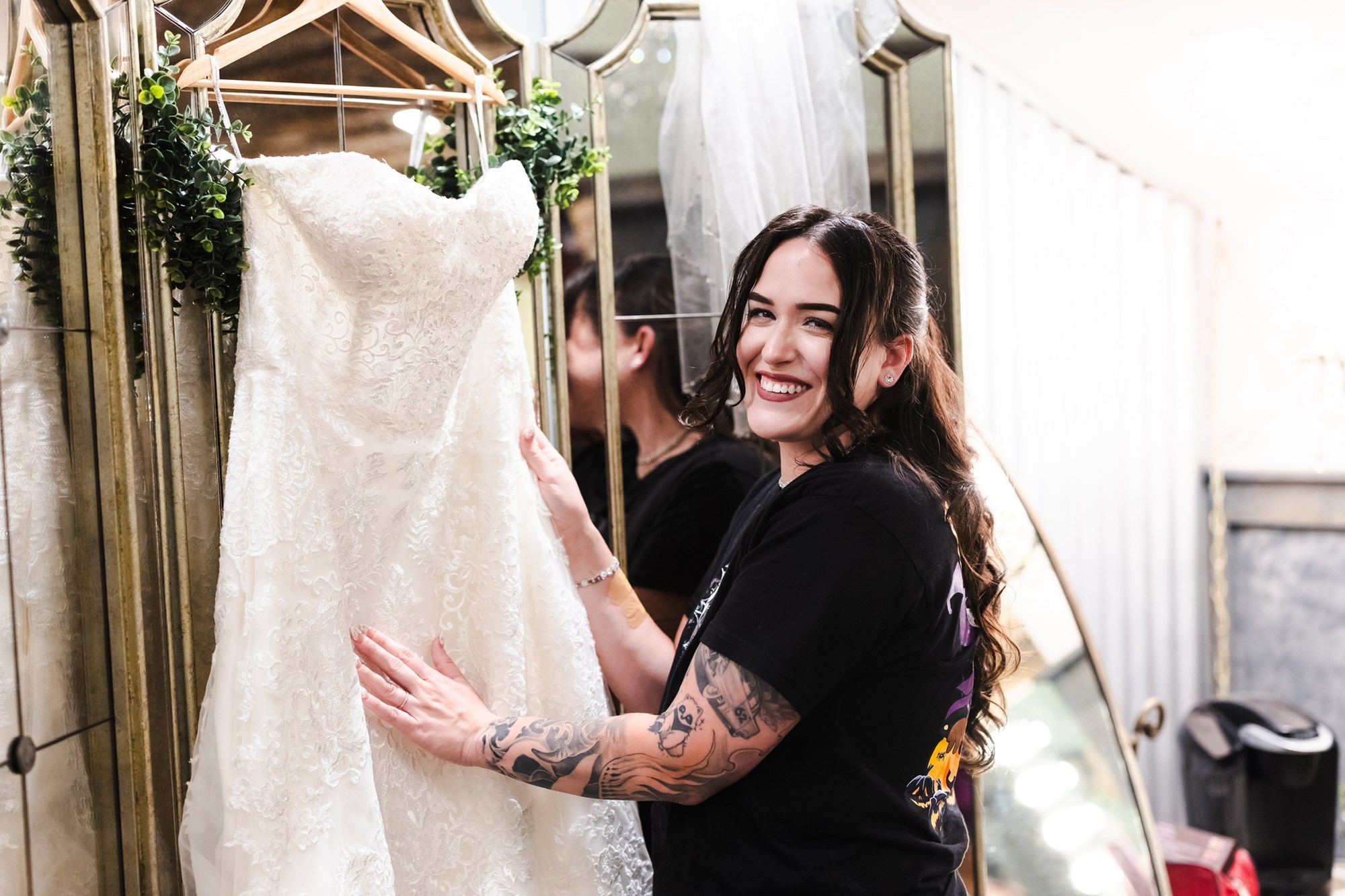 Nina smiling beside her lace wedding dress before the ceremony