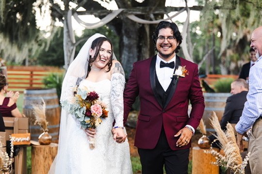 Nina and Ayrton walking back down the aisle after their outdoor ceremony