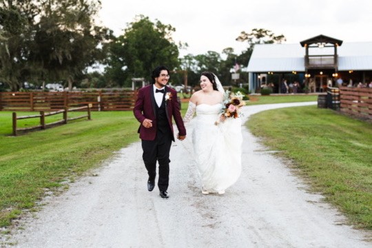Nina and Ayrton walking hand in hand along the ranch lane