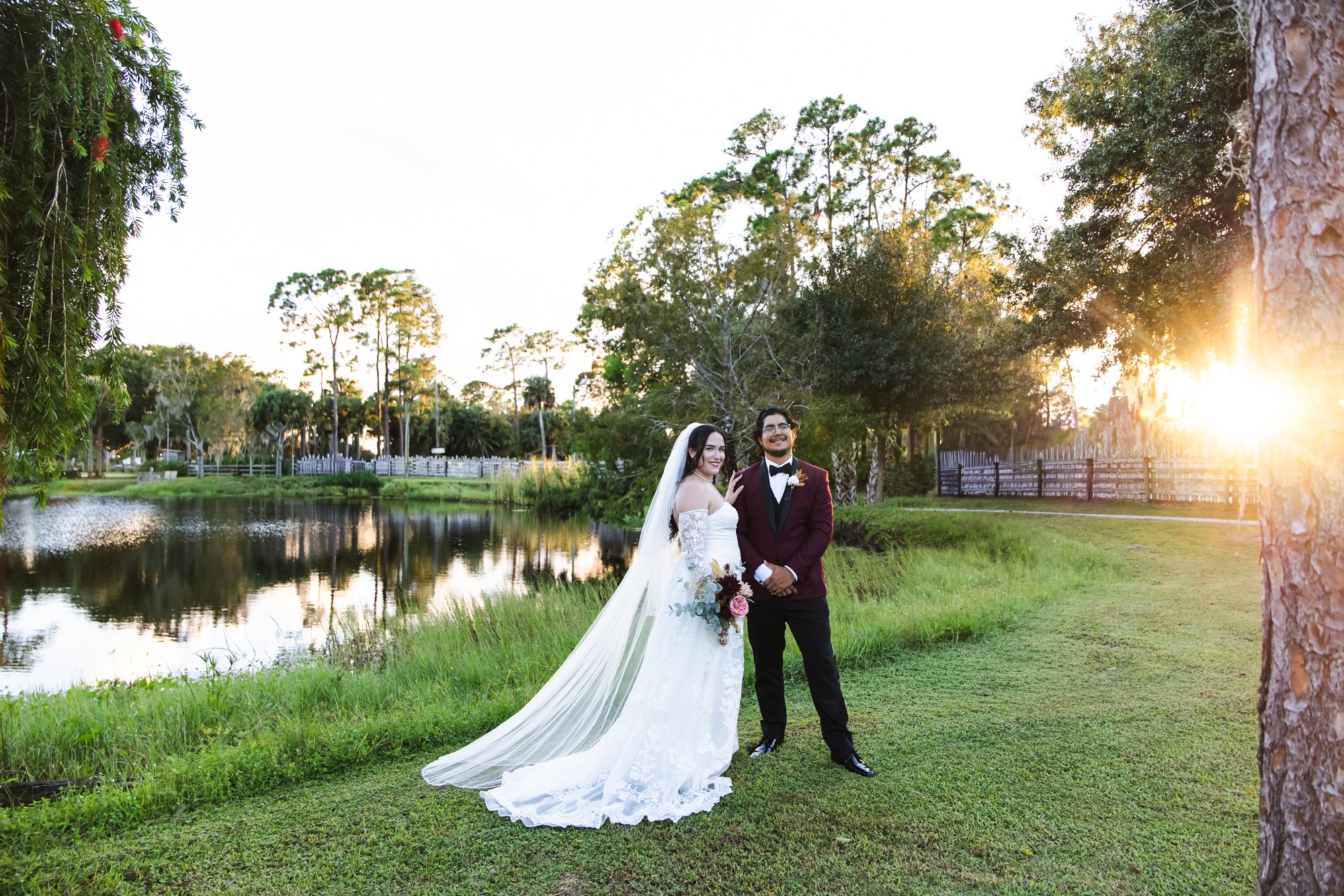 Nina and Ayrton beside the pond at Rockin H Ranch as the sun sets through the trees