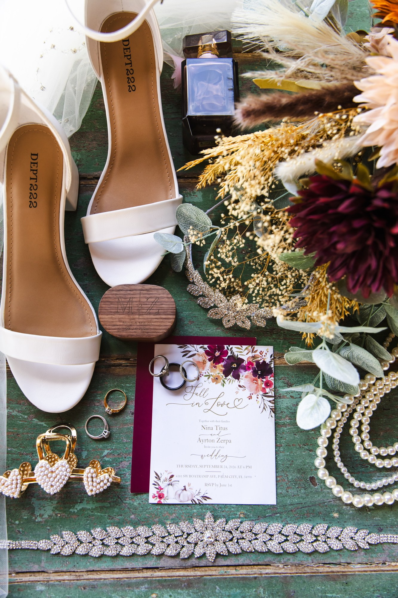 Nina and Ayrton’s invitation, rings, bridal shoes and autumn-colored flowers