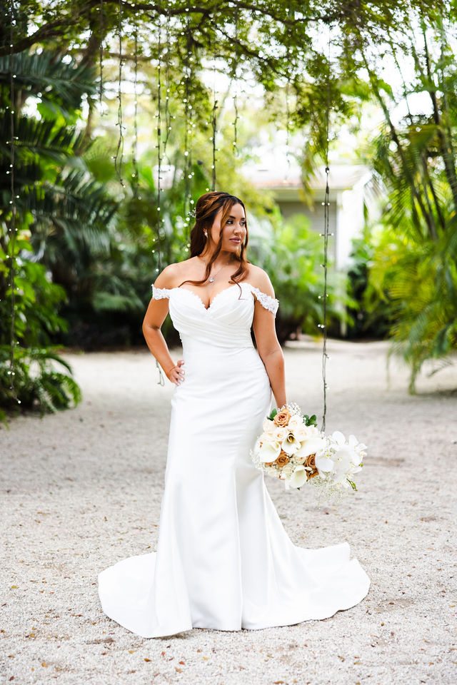 Full-length bridal portrait on a shaded garden path