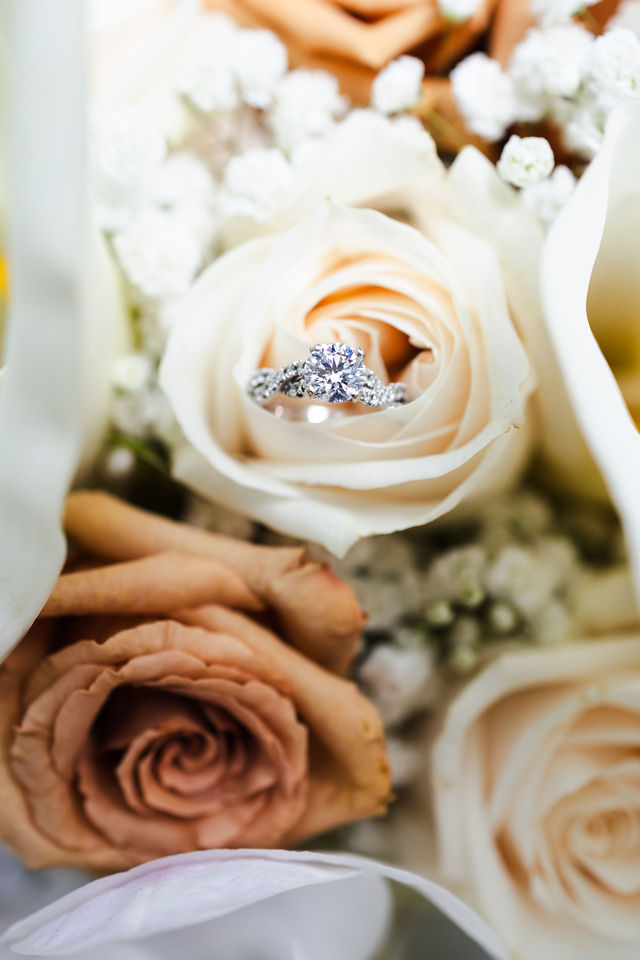 Sarah's wedding ring nestled inside a cream rose