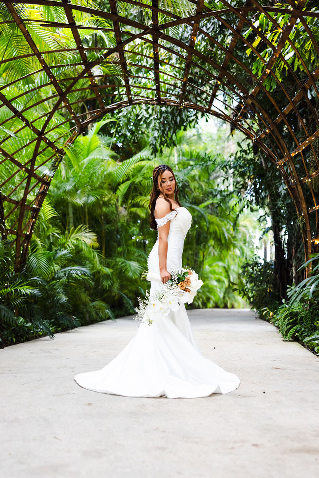 Sarah beneath the venue's natural tropical archway