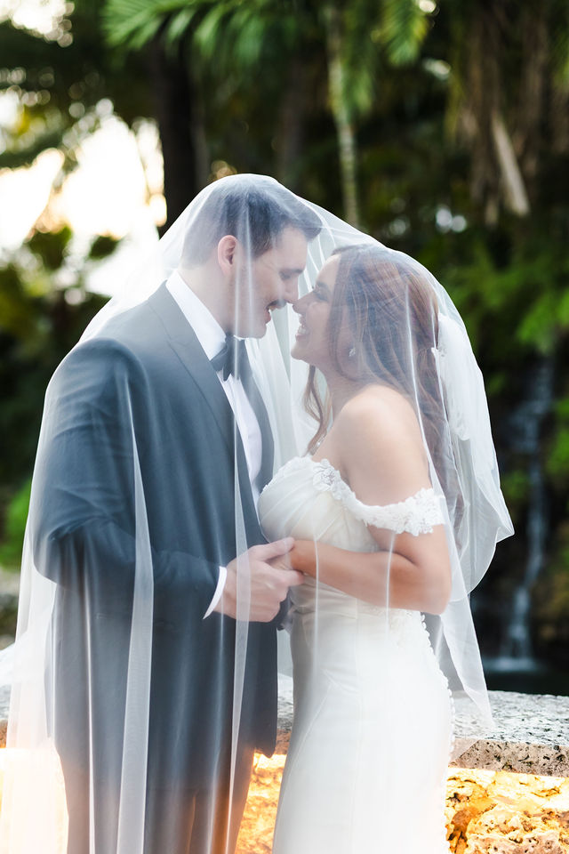 Intimate newlywed portrait beneath Sarah's veil