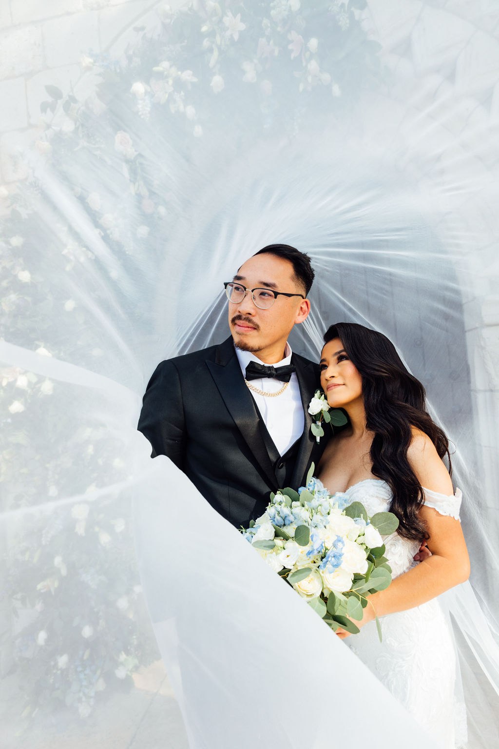 An overhead portrait of Dao and Karina framed by the bride’s veil