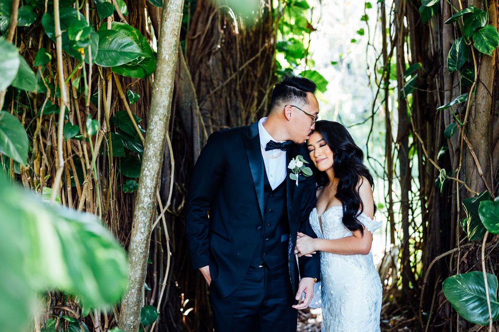 Dao and Karina embracing beneath the garden’s hanging roots