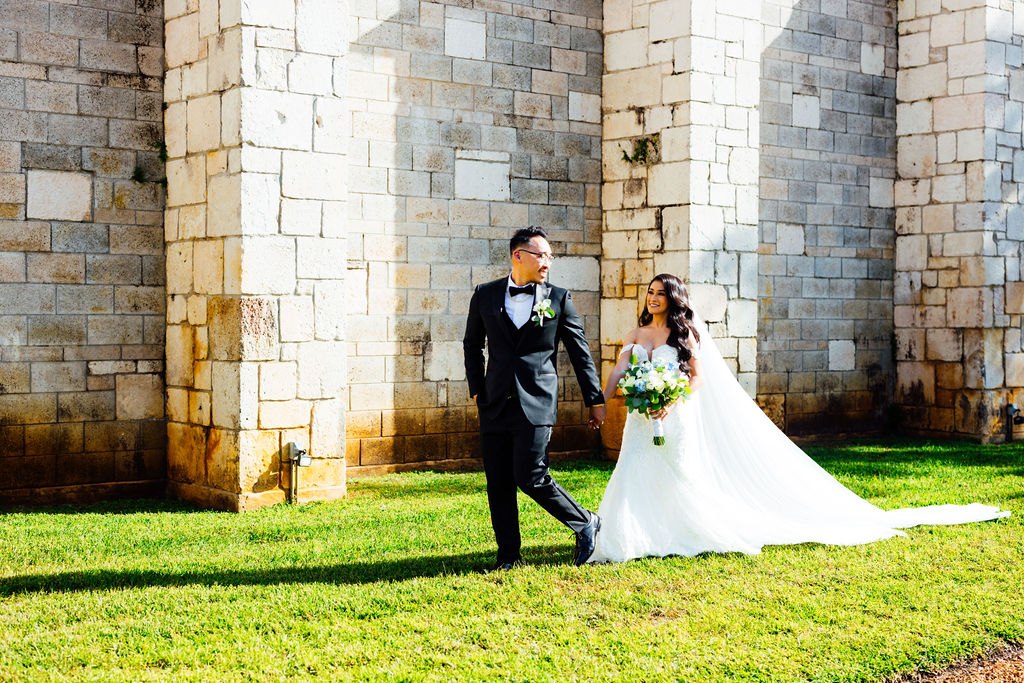 Dao and Karina walking together beside the monastery’s stone architecture